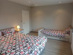 een slaapkamer met 2 bedden en een tafel en een lamp bij Bruges Brujas holiday house in Brugge