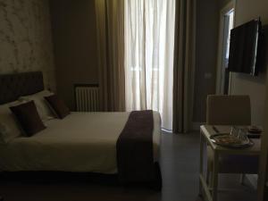 a hotel room with a bed and a window at 29 Venti Luxury in Palermo
