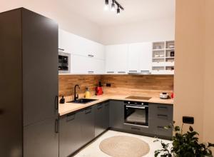 a kitchen with white cabinets and stainless steel appliances at Marlis' Home in Golem