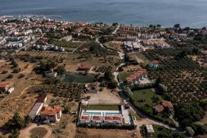 an aerial view of a city with houses and the ocean at Saint John Halkidiki in Nikiti