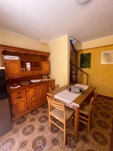 a kitchen with a wooden table and wooden cabinets at Villino indipendente Stella in Anzio