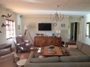 a living room with a couch and a tv at The Jones in Kaapsehoop