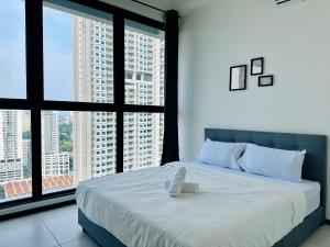 a bedroom with a large bed with large windows at Condo In Georgetown Familystay 3BR-10PAX in Jelutong +139 photos