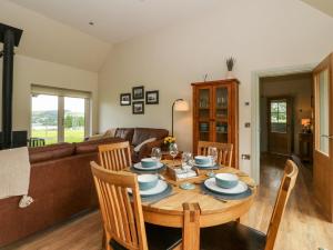 a living room with a table and a couch at Strawberry Cottage in Blairgowrie +27 photos