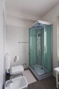 a bathroom with a glass shower and a toilet at Locanda Alla Posta in Cavaso del Tomba