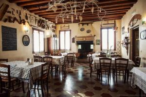 a dining room with tables and chairs in a restaurant at Locanda Alla Posta in Cavaso del Tomba
