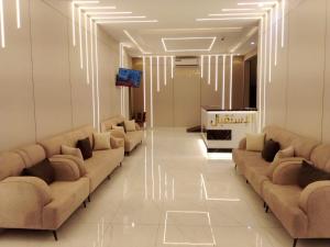 a lobby with couches and a television in a building at اصيل الفاخره المخدومه in Taif
