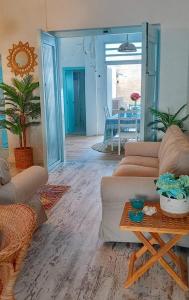 a living room with two couches and a table at Villarosario in Piles