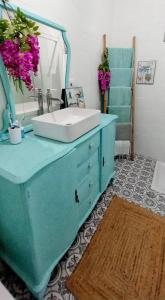a bathroom with a blue sink and a mirror at Villarosario in Piles +39 photos