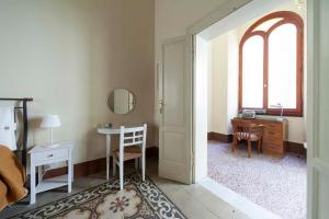 a bedroom with a bed and a desk and a table at B&B del Corso in Ascoli Piceno