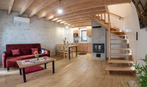 a living room with a red couch and a staircase at Bieszczadzkie Wzgórze Domki 724-472-882 in Polańczyk