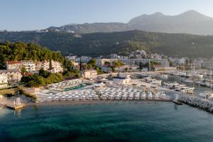 an aerial view of a harbor with umbrellas and a city at Lazure Hotel & Marina in Herceg-Novi