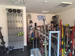 a room with skis and ski equipment in it at Apartman 22, Brzeće Centar in Mramor +13 photos