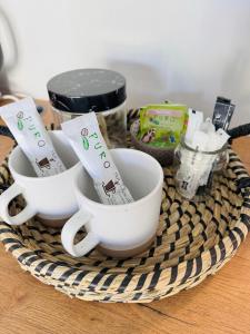 a basket with three coffee cups on a table at Studio #2 in East London