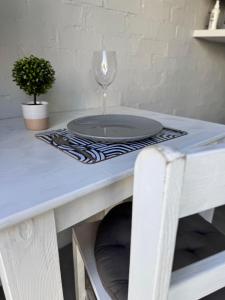 a table with a plate and a wine glass on it at Studio #2 in East London +1 photo