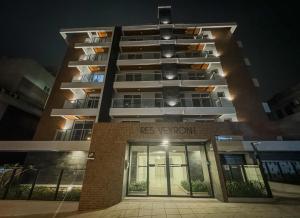 a tall apartment building at night with the front entrance at Studio Premium Florianópolis in Florianópolis