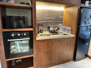 a kitchen with a sink and a microwave at Hacienda Bay Lagoon and Seaside Serviced Cabana - Le Sidi hotel in El Alamein
