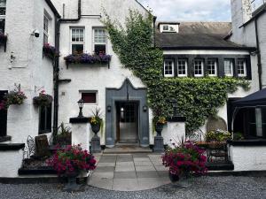 a white house with flowers in front of it at Abbotsford Hotel in Ayr