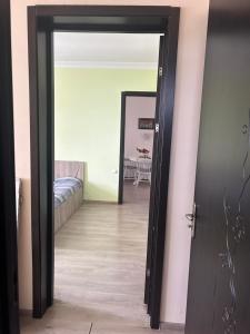 a door leading into a room with a bed at Kobuleti Family apartment in K'obulet'i