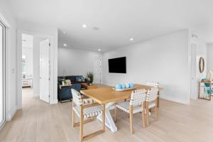 a dining room and living room with a table and chairs at Emerald Oasis Deluxe Waterfront Gem, Heated Pool with Dock in Marathon +81 photos