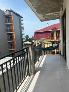 a hammock on the balcony of a building at Kobuleti Family apartment in K'obulet'i