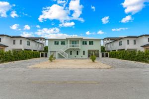 an empty parking lot in front of a house at Emerald Oasis Deluxe Waterfront Gem, Heated Pool with Dock in Marathon