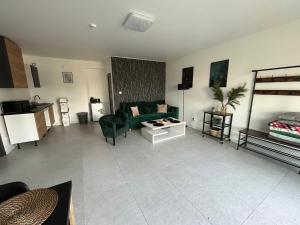 a living room with a couch and a bed at Koniec Świata - Nowa Stodoła Mikolajki in Stare Sady