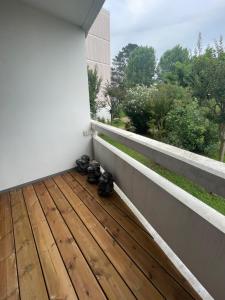 a balcony with a bunch of shoes on the floor at Appartement calme à Anglet in Anglet +1 photo