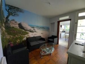 a living room with a painting on the wall at Douceur Vendéenne in La Roche-sur-Yon +7 photos