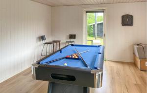 a pool table in a living room with a pool table at 3 Bedroom Nice Home In Skjern in Skjern