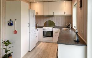 a kitchen with white cabinets and a white refrigerator at 3 Bedroom Nice Home In Skjern in Skjern