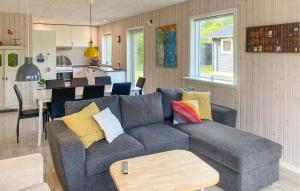 a living room with a couch and a kitchen at 3 Bedroom Nice Home In Skjern in Skjern