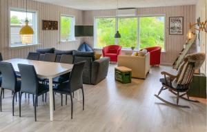 a living room with a table and chairs at 3 Bedroom Nice Home In Skjern in Skjern