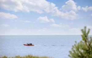 a boat in the middle of the water at 1 Bedroom Gorgeous Home In Aakirkeby in Åkirkeby +9 photos