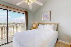a bedroom with a bed and a large window at The Breeze in Gulf Shores