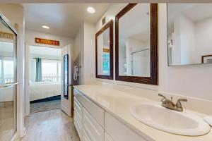 a bathroom with a sink and a mirror at The Breeze in Gulf Shores +18 photos