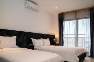 Voodi või voodid majutusasutuse Manta Surf Hotel toas