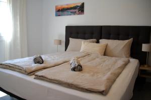 a large bed with two blankets and pillows on it at Villa de Gracia Casa 4 in Tordera +77 photos
