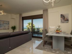 a living room with a couch and a table at Palma Villa & Suite With Pool in Nea Kalikratia