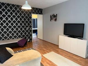 a living room with a flat screen tv on a wall at Apartment Mäyränkatu in Kokkola