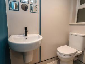 a bathroom with a white sink and a toilet at Apt 1 Hunter's Quay in Bridlington