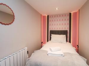 a bedroom with a bed with two towels on it at Apt 1 Hunter's Quay in Bridlington