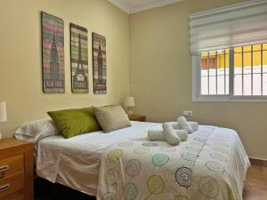 a bedroom with a bed with two pillows on it at Villa Victoria - Ole Solutions in El Puerto de Santa María