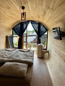 a bedroom with two beds and a large window at Zatoka Marina II in Mechelinki