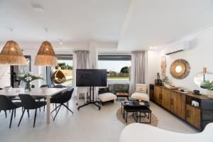 a living room with a table and a dining room at Saint John Halkidiki in Nikiti