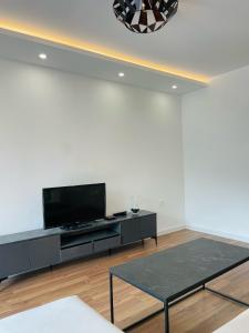 a living room with a tv and a table at Hacienda DM in Visoko