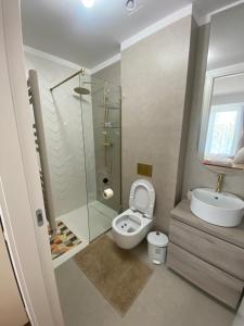 a bathroom with a shower and a toilet and a sink at Apartament Naty S 403 Vogh Olimp in Olimp +4 photos