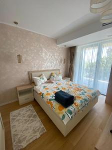 a bedroom with a bed with a bag on it at Apartament Naty S 403 Vogh Olimp in Olimp