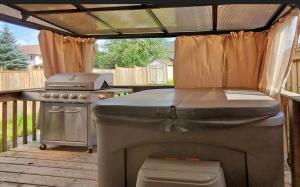 an outdoor kitchen with a grill and a stove at Guelph house in Guelph +29 photos
