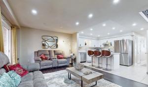 a living room with a couch and a kitchen at Guelph house in Guelph